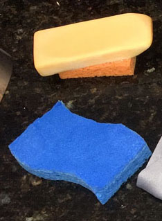 how to clean baseball pants - Image of blue sponge and Fels Naptha soap bar.